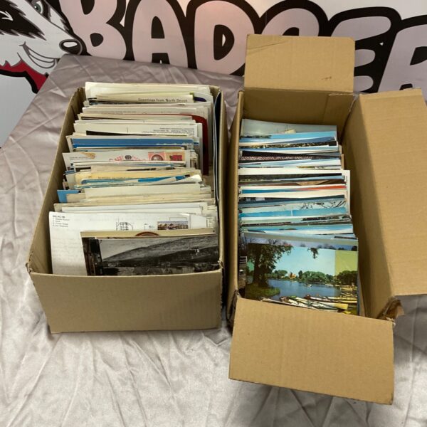 Two boxes filled with a collection of vintage postcards.