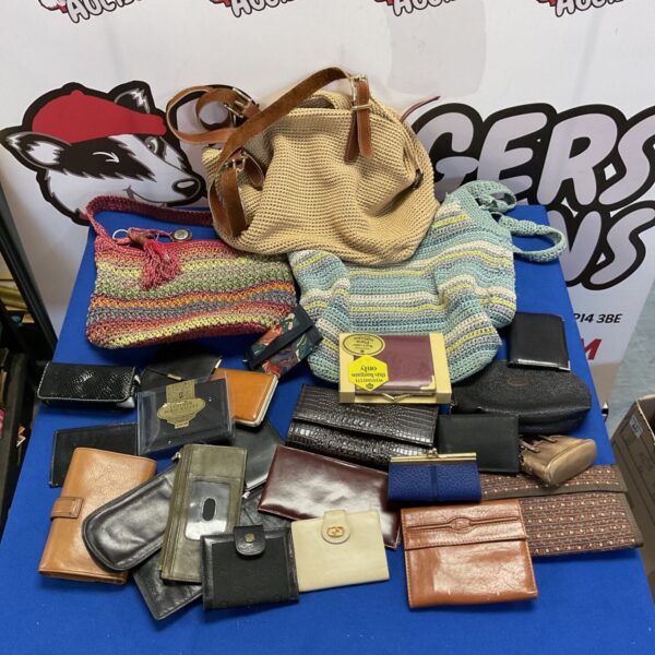 Vintage purse lot including Gucci and Mulberry bags on a blue table.