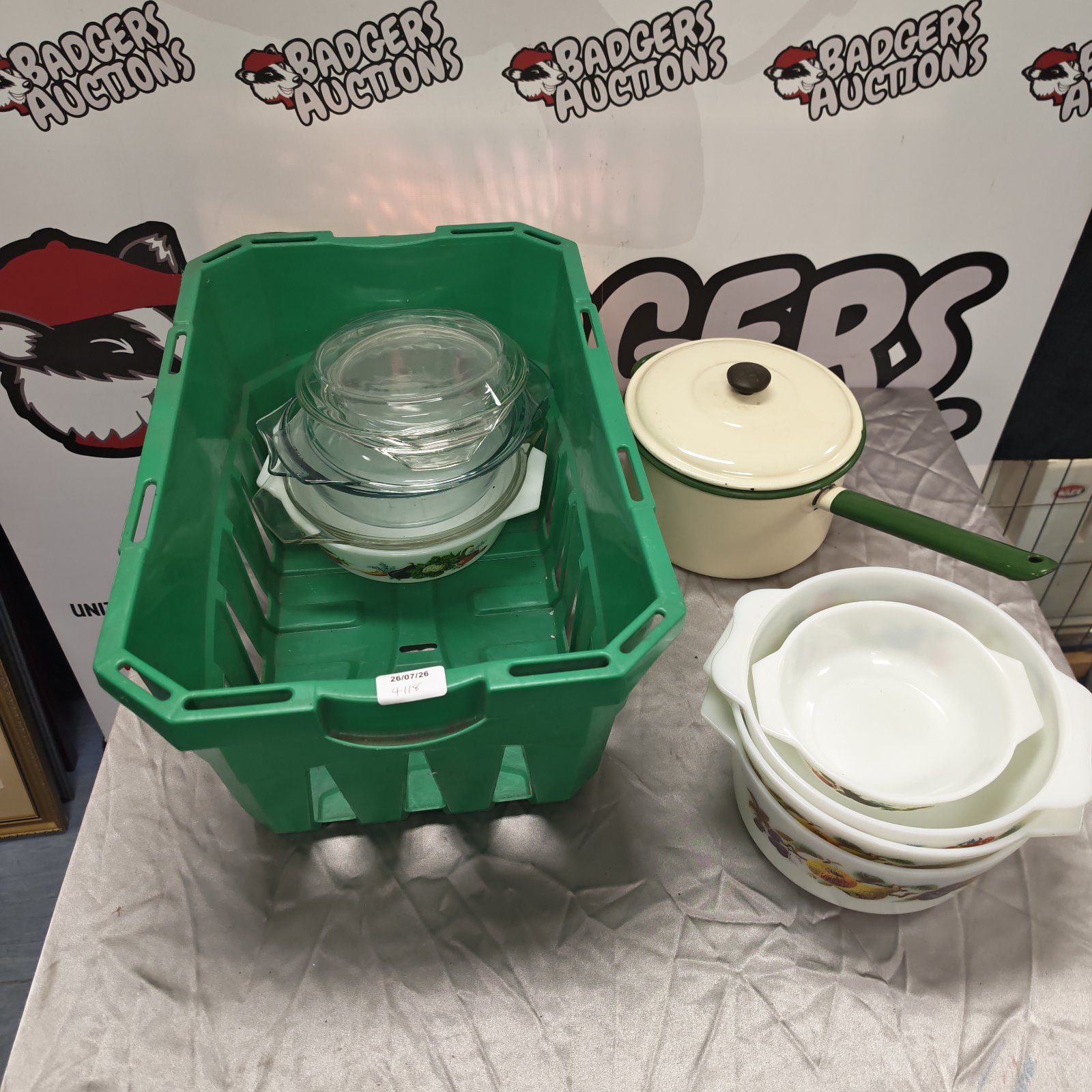 Vintage Pyrex dishes and Judge enameled pot in a kitchen lot.