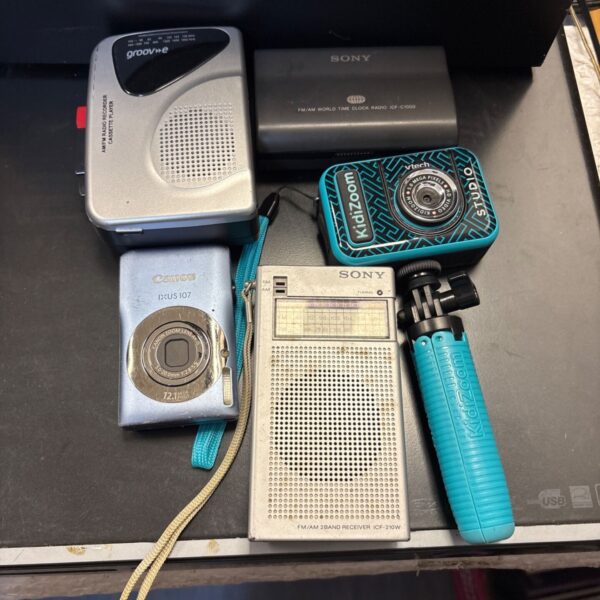 Vintage radio and Canon IXUS 107 camera lot for collectors.