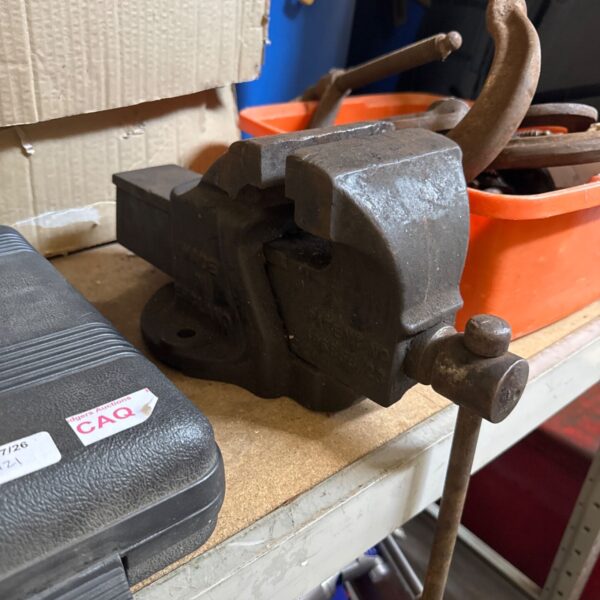 Vintage Record No4 bench vice in a workshop setting.