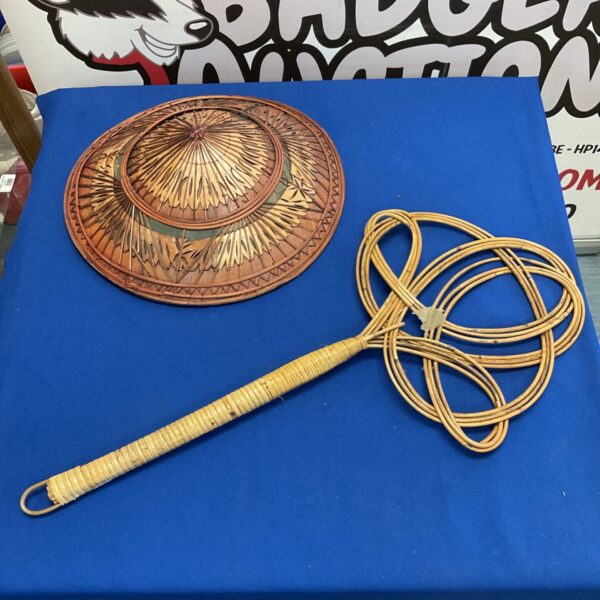 Vintage rug beater with woven head and bamboo handle.
