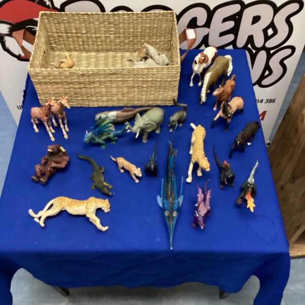Vintage wicker basket filled with safari and fantasy toys.