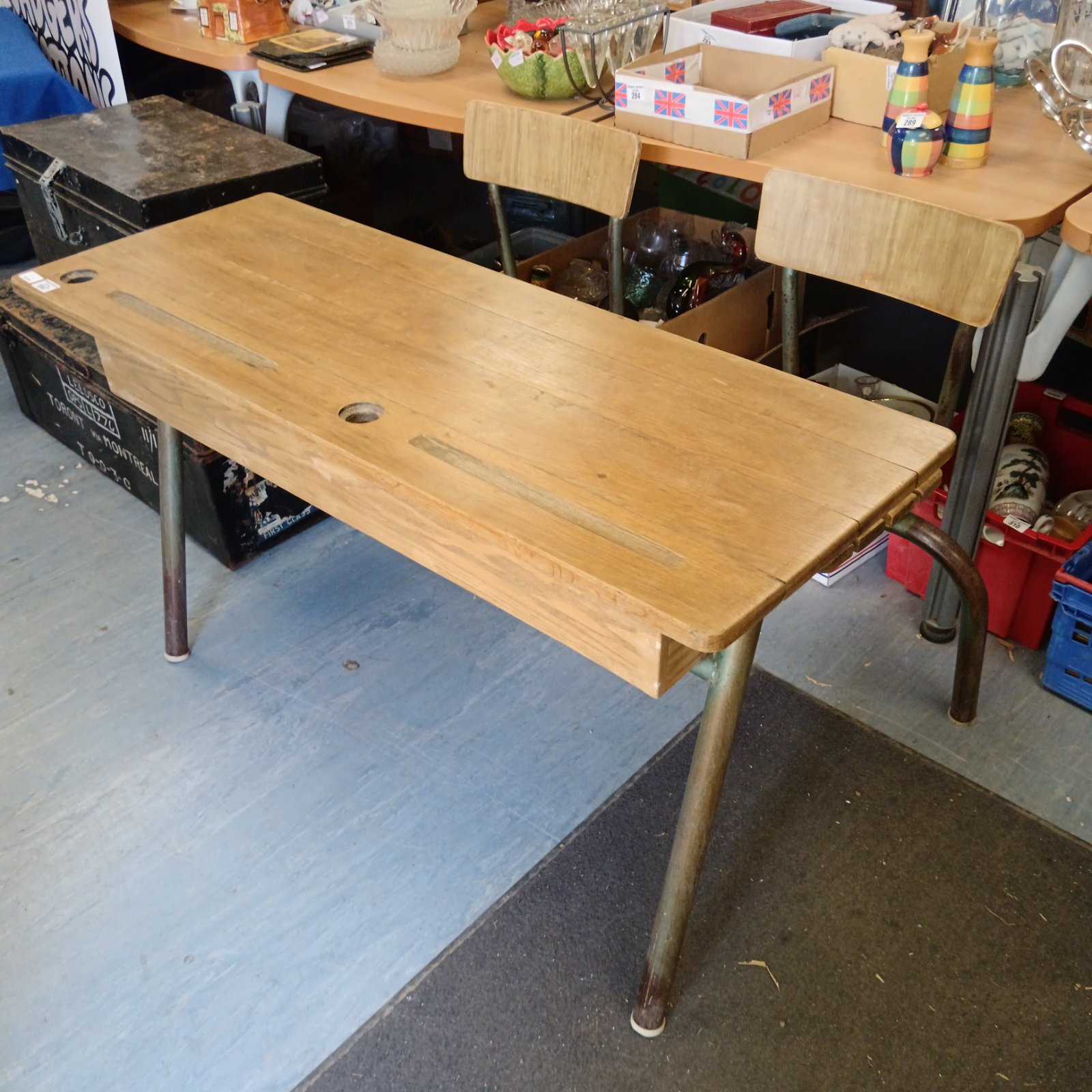 Vintage two-seater school desk with oak top and metal frame.