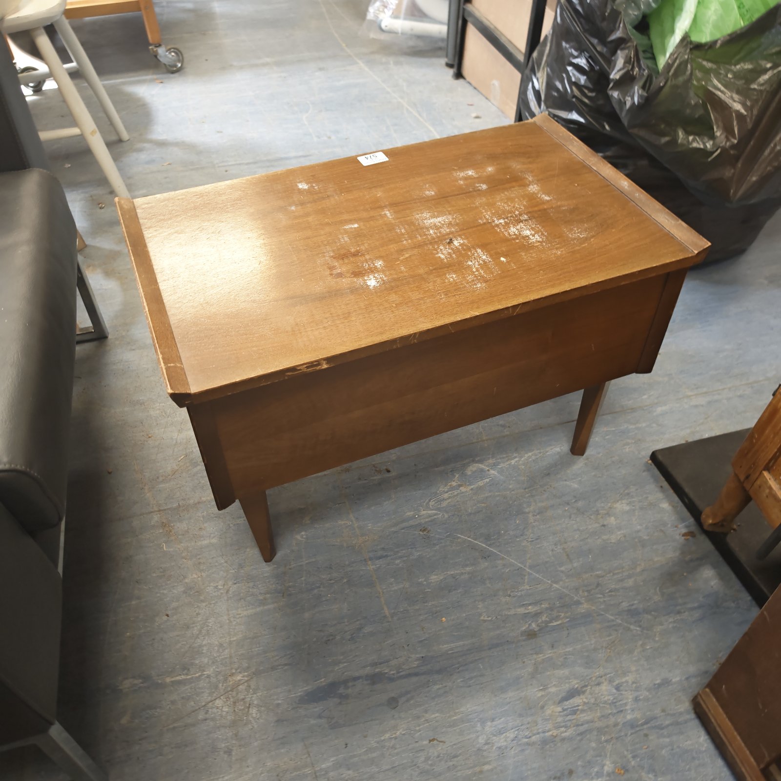 Vintage wooden sewing box with hinged lid and tapered legs.