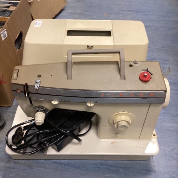 Vintage Singer sewing machine with foot pedal, classic retro style.