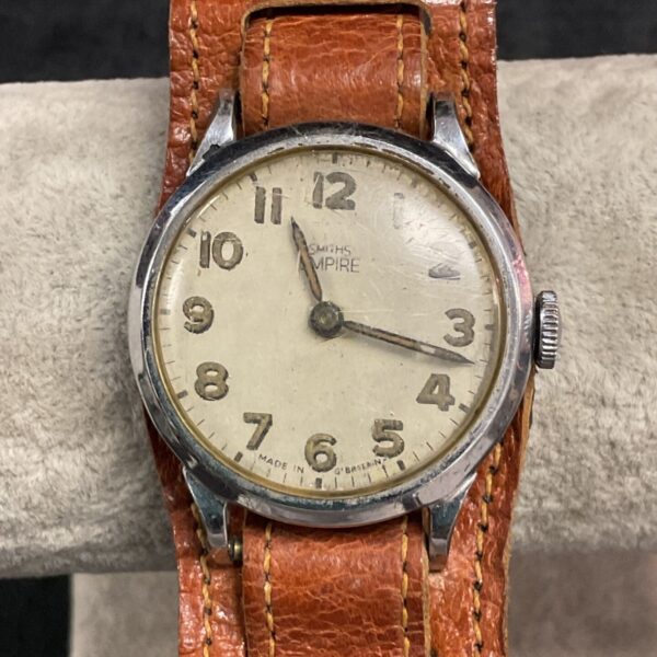 Vintage Smiths Empire wristwatch with clear dial and patina.
