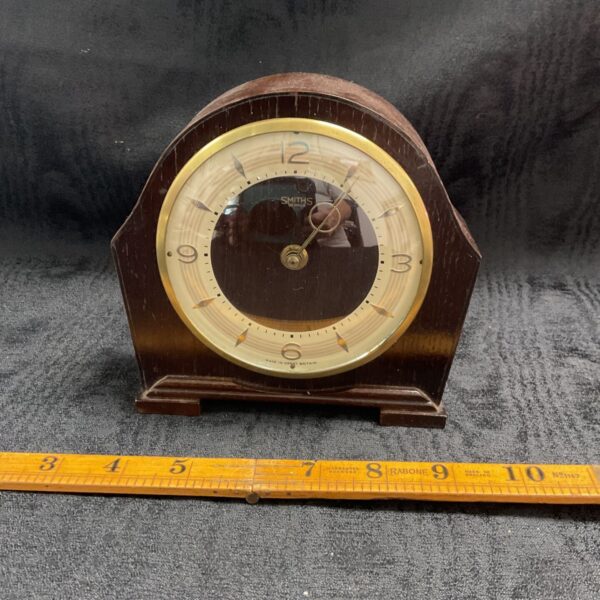 Vintage Smiths mantle clock with wooden case and clear dial.