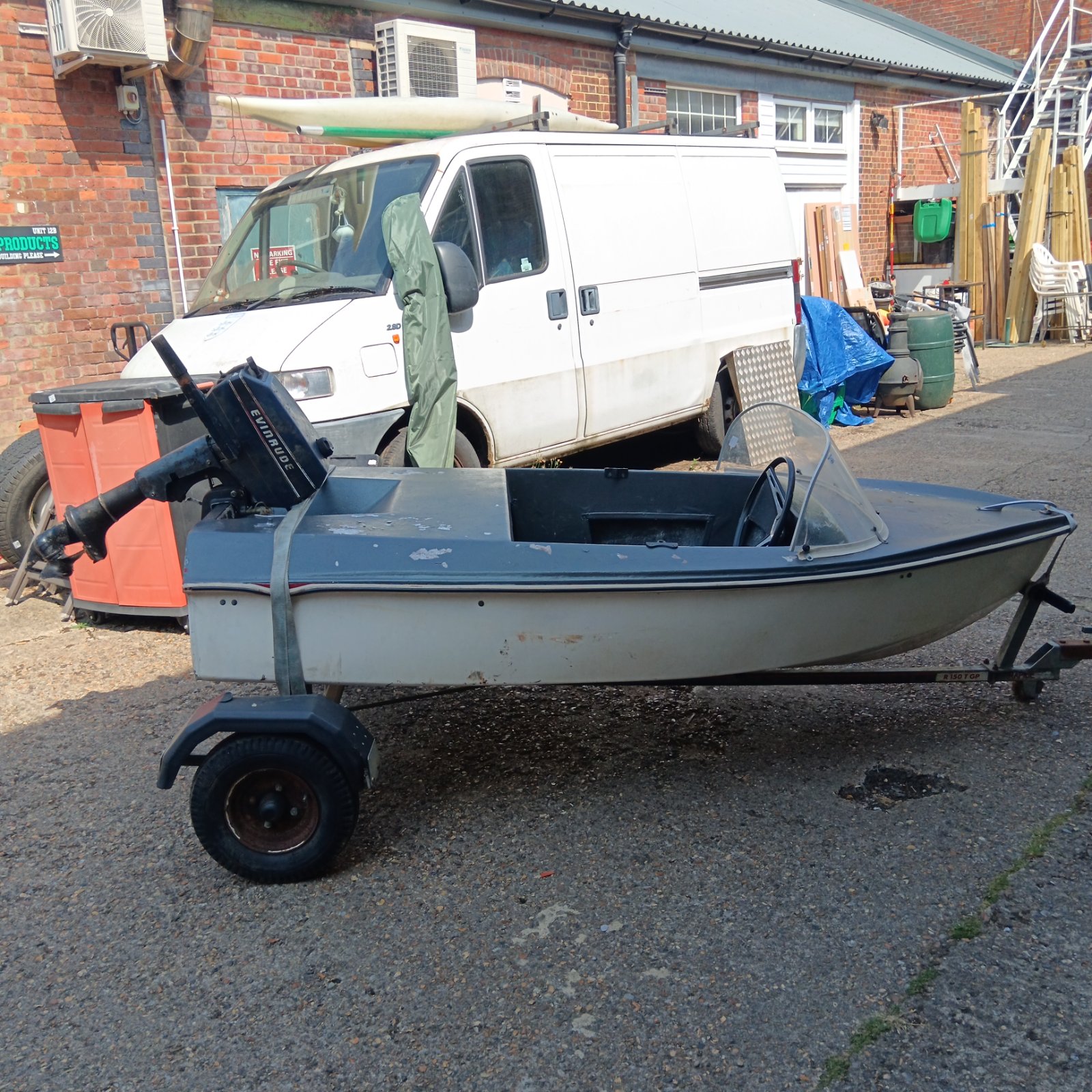 Vintage speedboat on a Rapide trailer with Evinrude outboard motor.