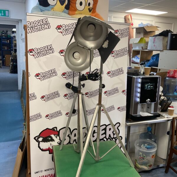 Two vintage spot lamps with folding legs for studio lighting.