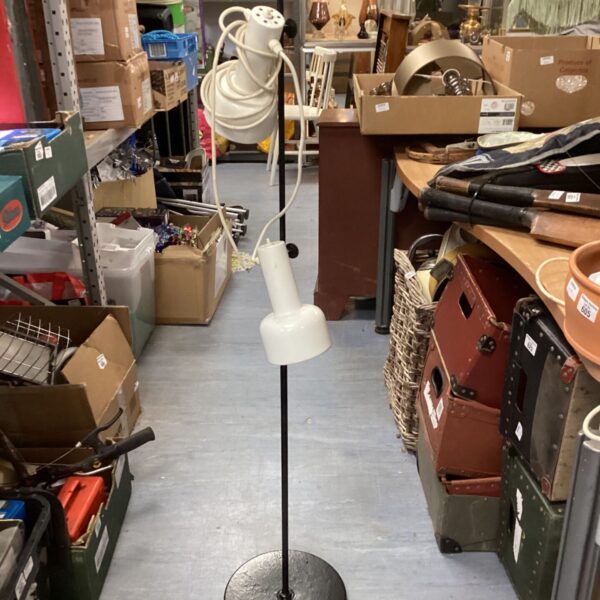 Vintage 1970s spotlight floor lamp in a room setting.