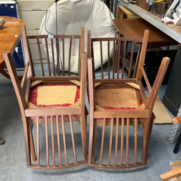 Set of four vintage stick back dining chairs with red leather seats.