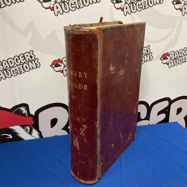 Front view of a vintage leather bound sundry ledger.
