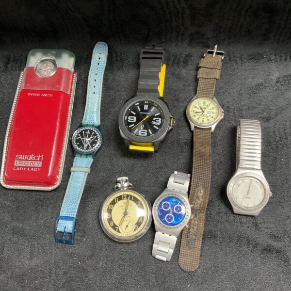 Vintage Swatch watch in a tray lot of mixed watches.