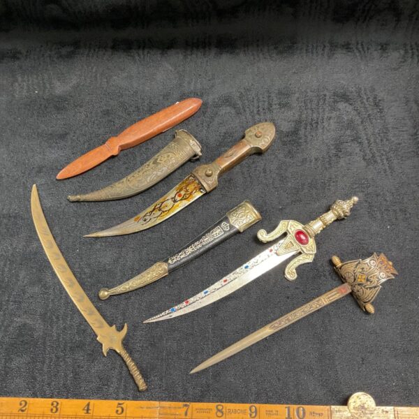 Lot of five vintage sword letter openers with ornate designs.