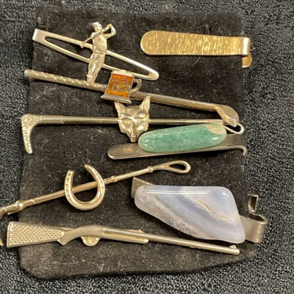 Vintage tie clip lot featuring various designs and materials.
