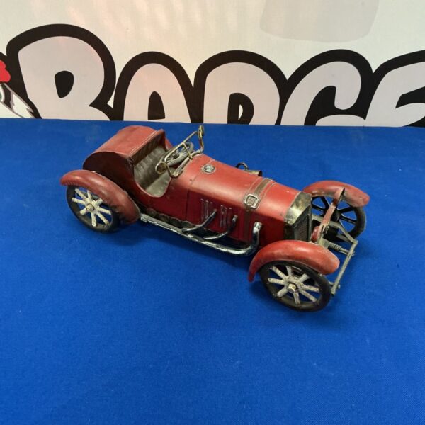 Vintage tin plate sportscar model, red with spoked wheels.