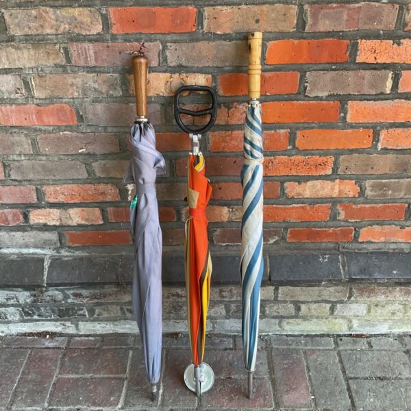 Vintage lilac umbrella and striped brolly with shooting stick.