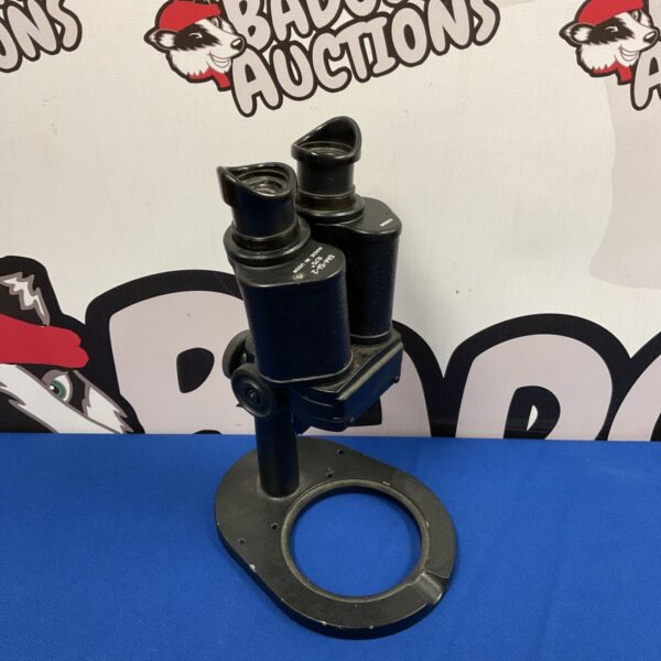 Vintage USSR binocular microscope with blue background.
