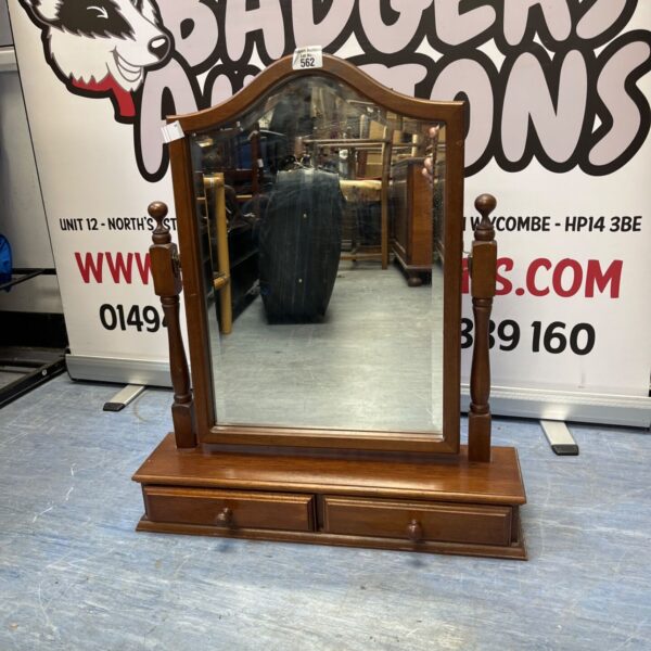 Vintage arched vanity mirror with wooden base and drawers.