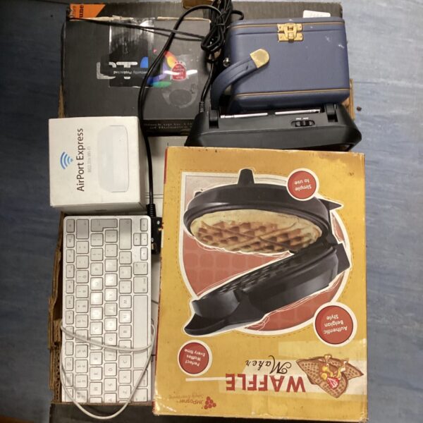 Vintage waffle maker in a box with other electrical items.