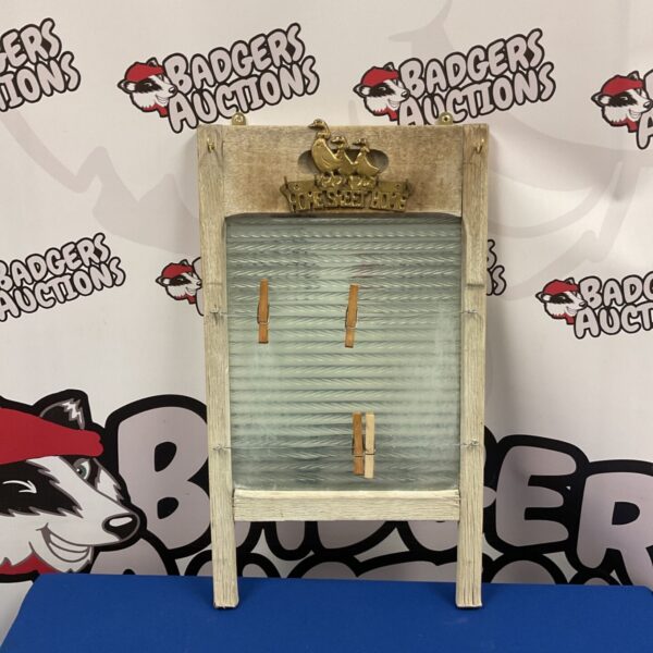 Vintage washboard repurposed as a pegboard with key hooks for rustic decor.