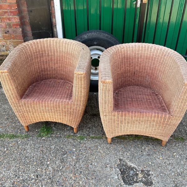 Vintage wicker armchair with oak legs, retro style seating.