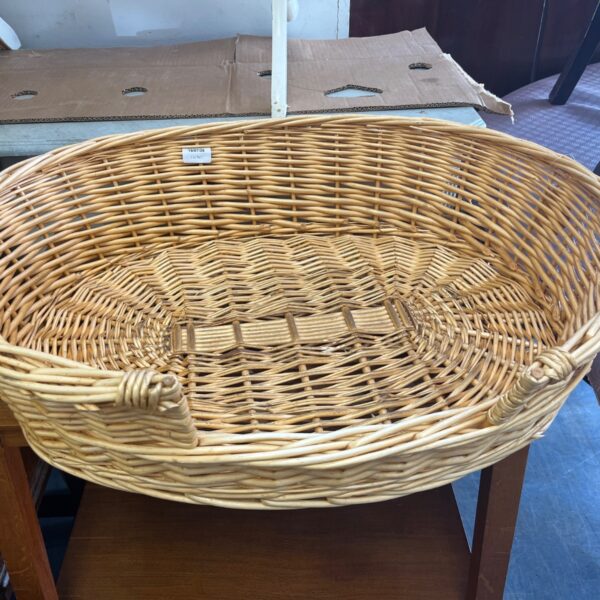Vintage wicker basket with a sturdy handle, ideal for farmhouse decor.