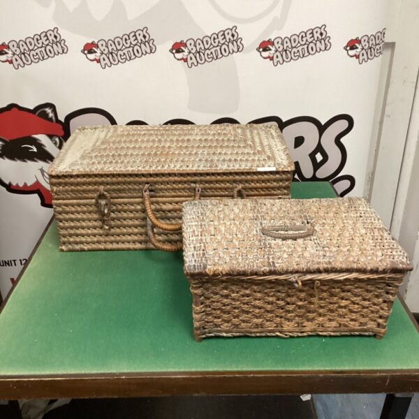 Pair of vintage wicker baskets with handles, ideal for storage.