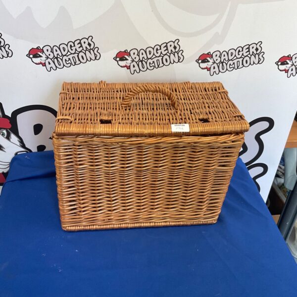 Vintage wicker picnic basket with a woven design and carrying handle.