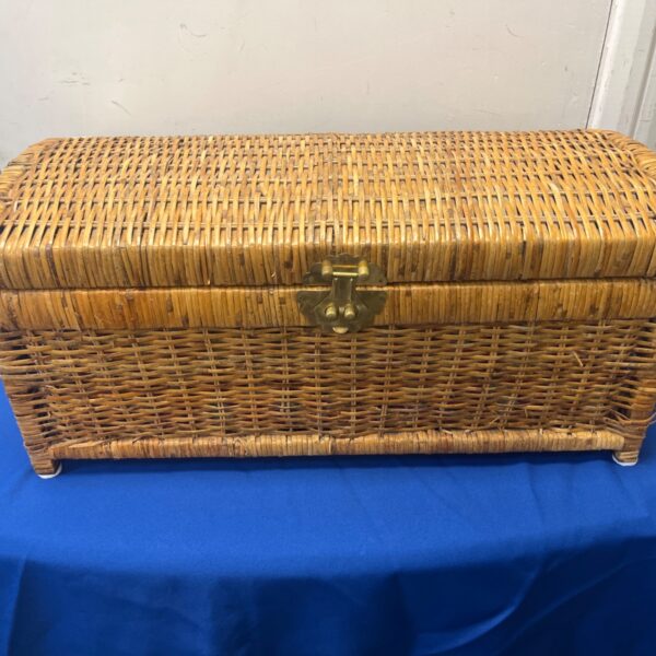 Vintage wicker trunk with brass hardware for storage and decor.