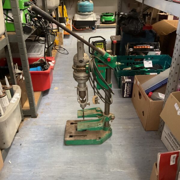 Vintage Wolf pillar drill in a workshop setting.