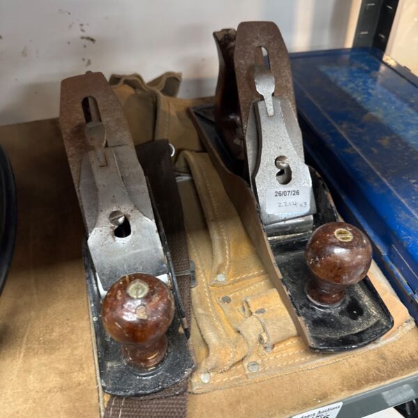 Vintage wood planes lot, showing signs of wear and use.