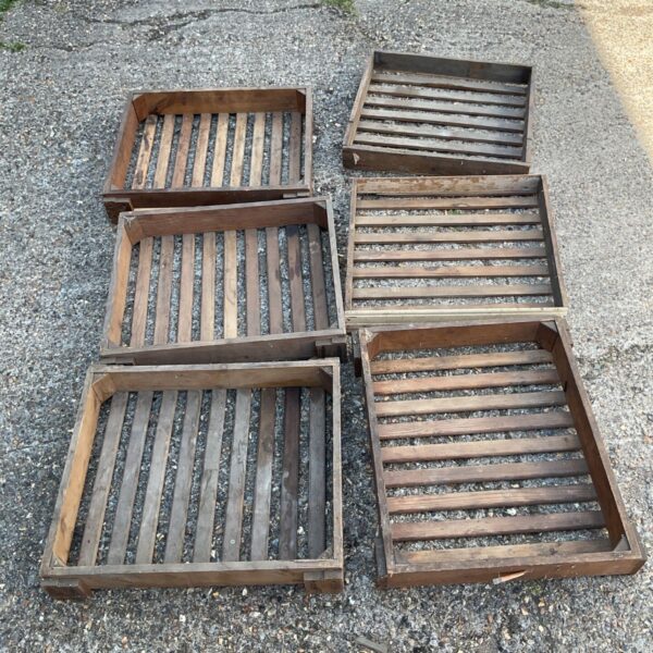 Six vintage wooden boxes with slatted sides, ideal for rustic storage.