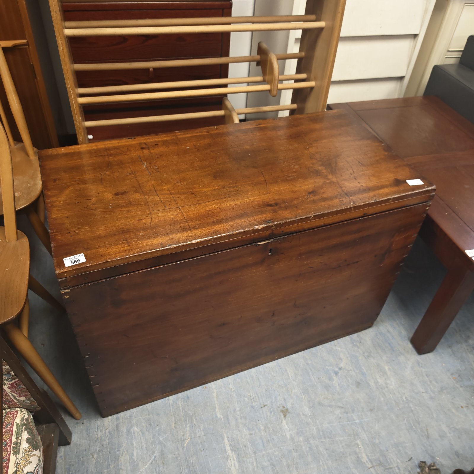 Vintage wooden chest with a lift-top lid, ideal for storage.