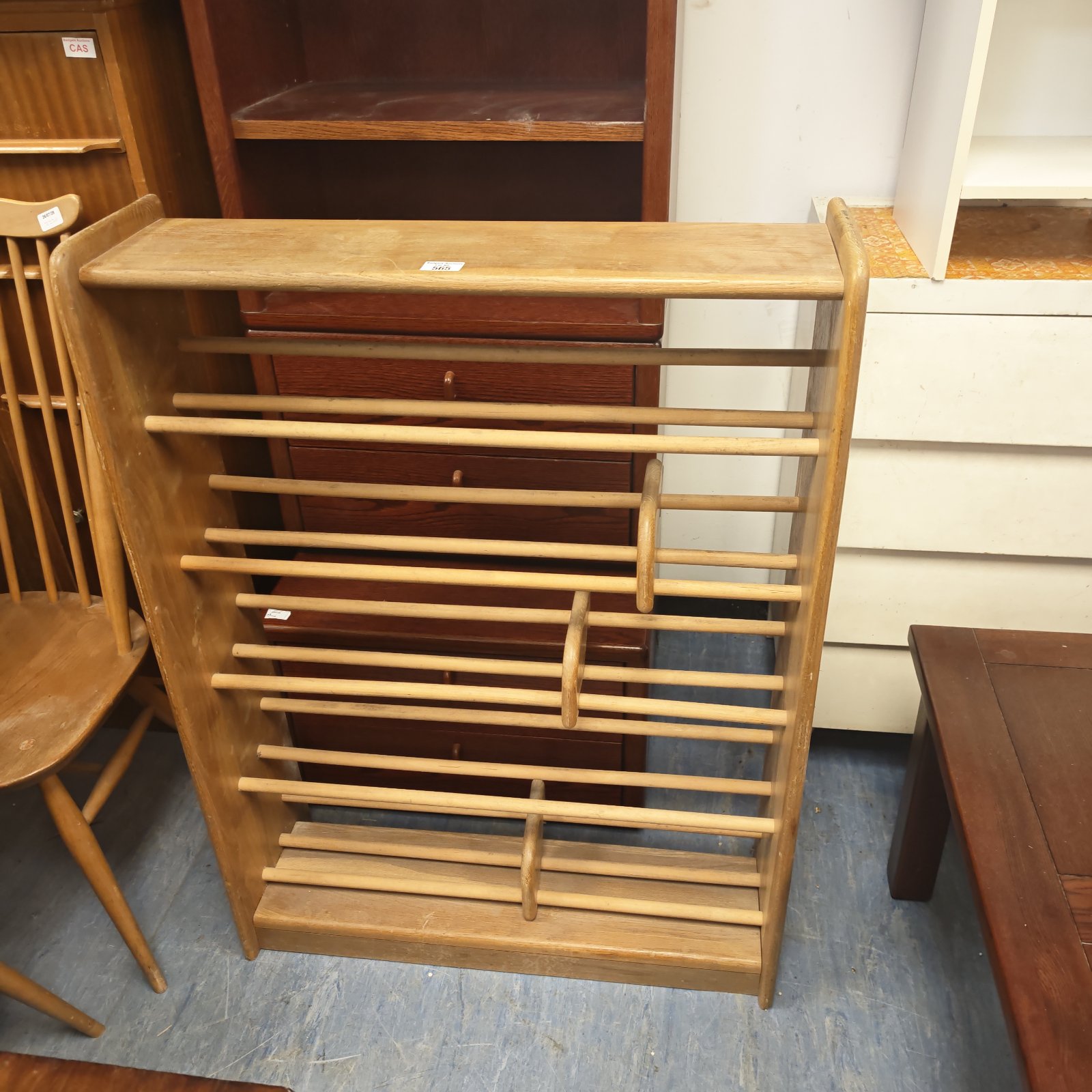 Vintage wooden shoe rack for hallway storage.