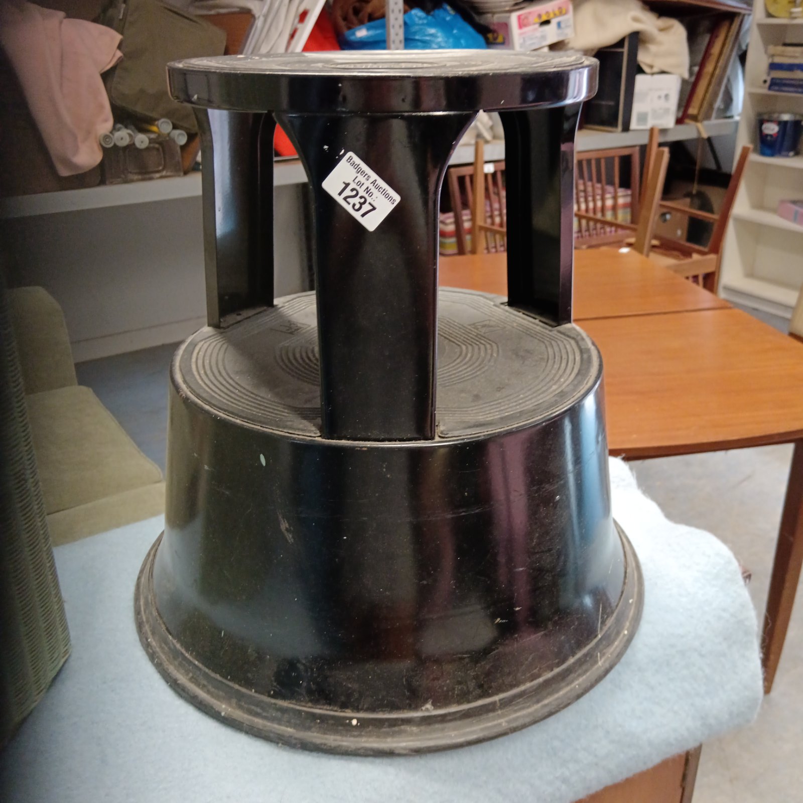 Vintage wooden stepper stool with tripod base.