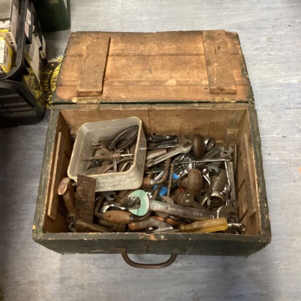 Vintage wooden tool box filled with antique hand tools.
