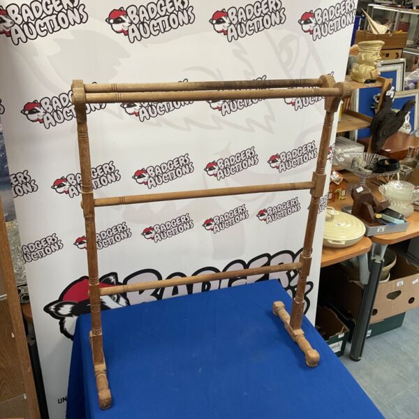 Vintage wooden towel rail for bathroom storage, rustic farmhouse style.
