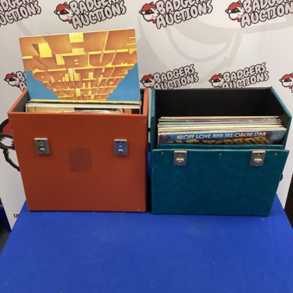 Dark blue vinyl record boxes containing 12 inch records, including Monty Python.