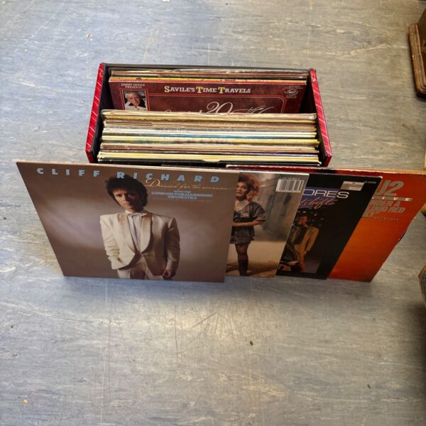 Stack of 12 inch vinyl records, including Cliff Richard and Tina Turner.