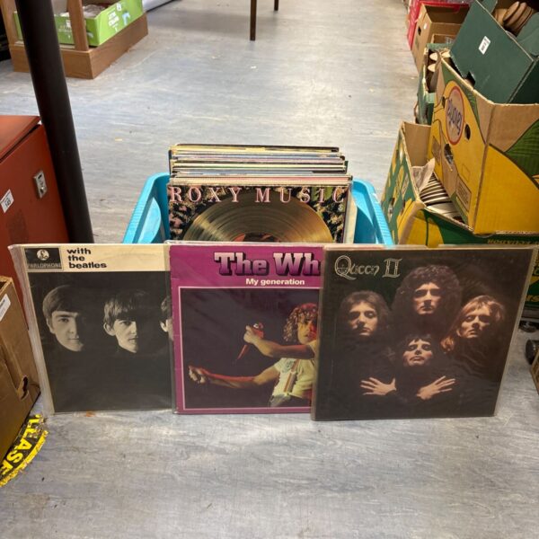 Collection of vinyl records including The Who, Queen and Beatles.