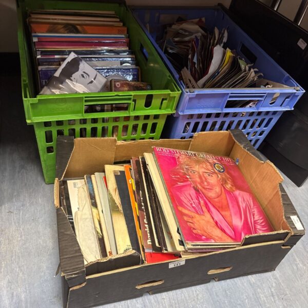 Mixed lot of vinyl records in green crates.