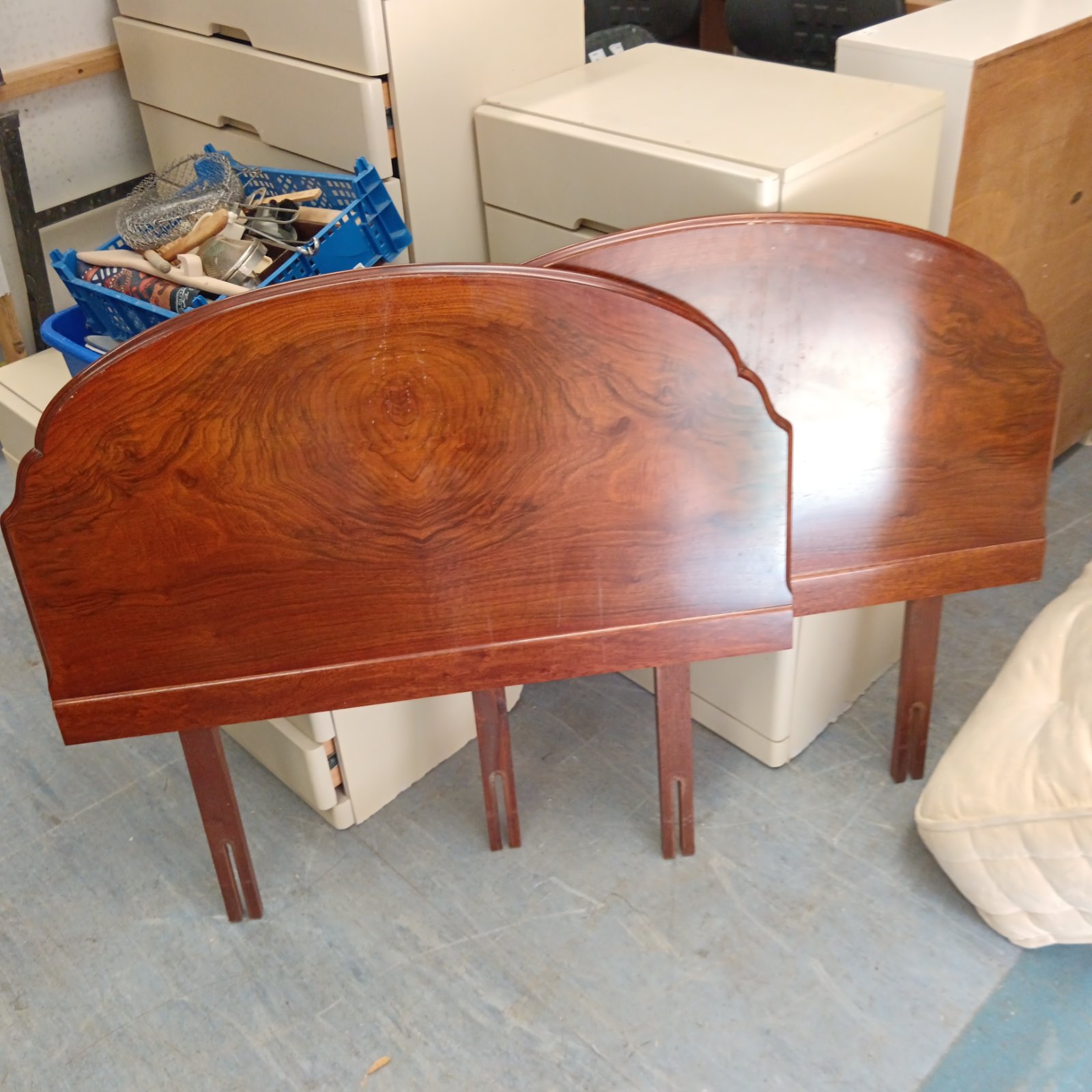 Vintage walnut bed headboards with curved tops and tapered legs.