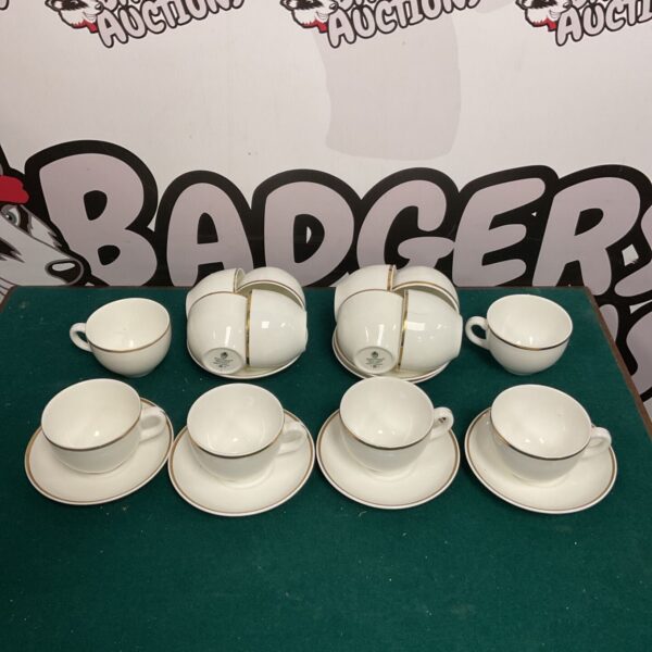 Vintage Wedgwood cups and saucers with white and gold detailing.
