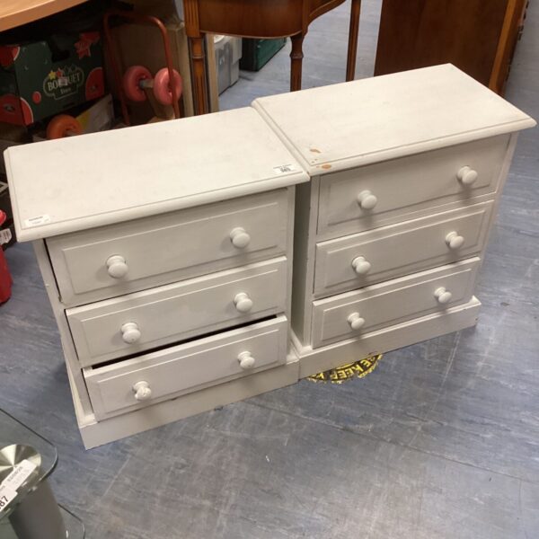 Pair of white three-drawer bedside cabinets for bedroom storage.
