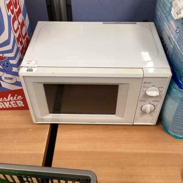 White 700w microwave appliance on a wooden surface.