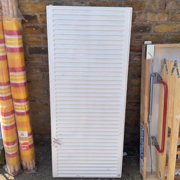 Used white panel radiator for central heating system, side view.