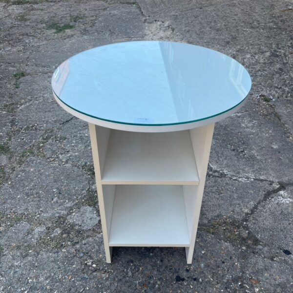 White round glass side table with two storage shelves.