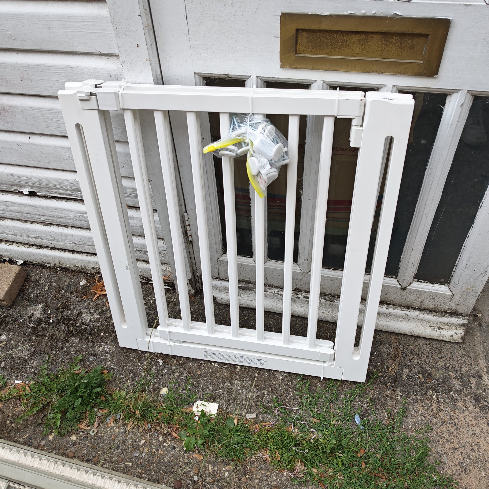 White wooden stair gate for securing hallways and stairways.